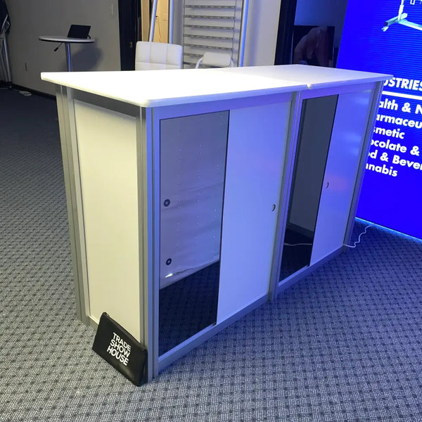 XRC9 Backlit Storage Counter with white countertop, silver frame, glass doors