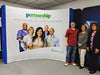 Blue and white curved banner with Partnership Health Center logo and smiling healthcare professionals for 10ft pop up display kit