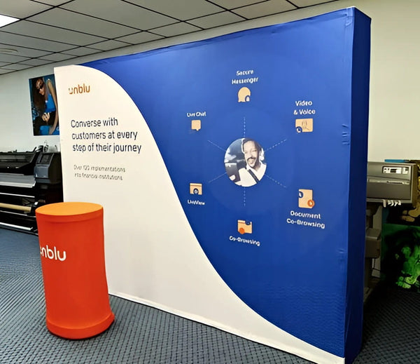 Unblu blue white banner on 10ft straight pop up display with customer service diagram