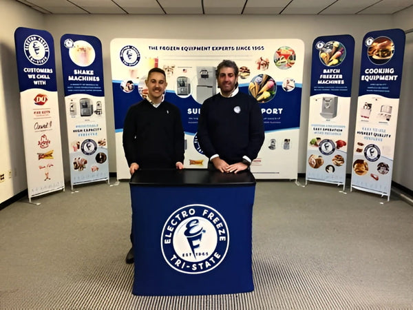 Blue Electro Freeze tablecloth with white Tai-State logo on 10ft display