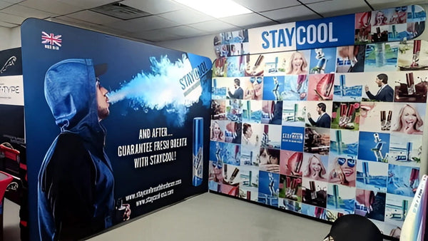 Blue and white stay cool banner on 10ft straight tension fabric display with hooded man exhaling mist