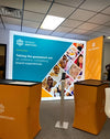 Orange fabric SEG lightbox stands with Sensory Spectrum logo