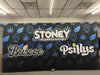 Black banner with blue cannabis leaf, smiling faces, and Stoney the Higher Standard text for Briscoe and Psillys on 20ft pop-up display