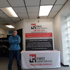 Man in blue hoodie and dark pants by 5ft tabletop pop up display with First Credit Services banner