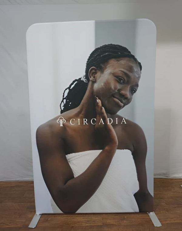 White Circadia standee woman with braided hair applying face mask