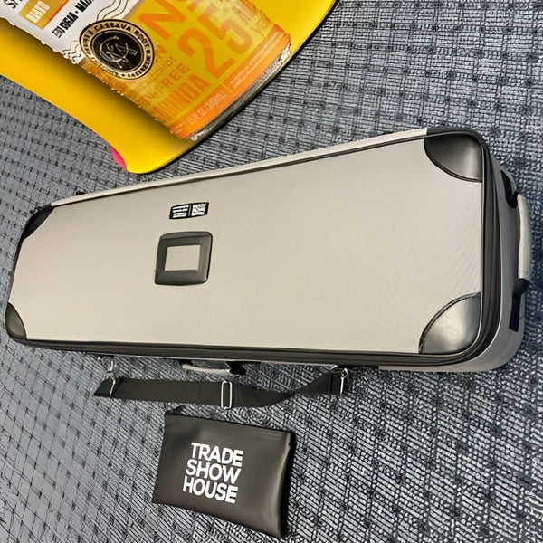 Silver-gray violin case with black corners and strap on 6ft curved display