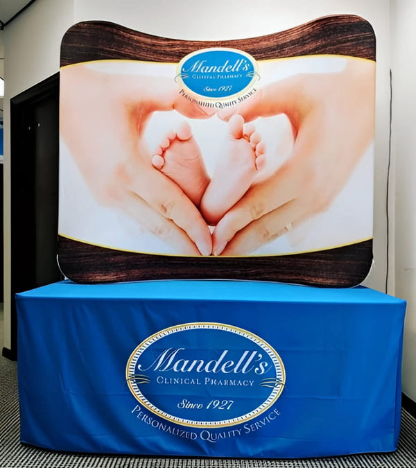 Blue Mandells Clinical Pharmacy Logo on 6ft Curved Tabletop Display