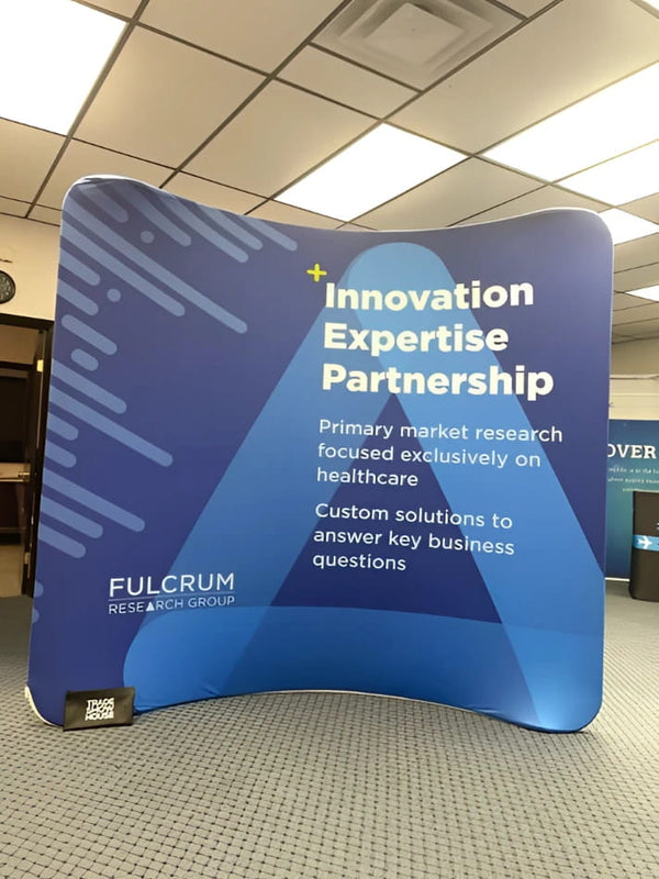 8ft curved tension fabric display with blue inflatable banner, white text, diagonal patterns