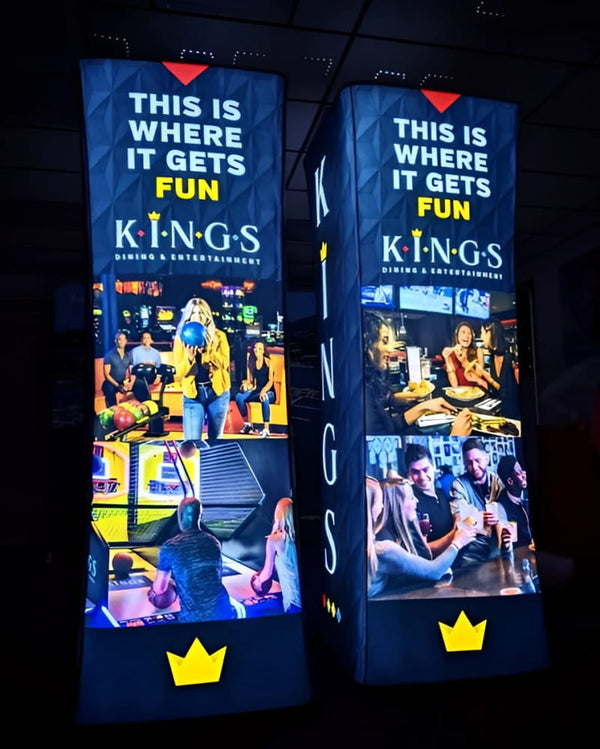 Two 8ft Kings Dining & Entertainment backlit inflatable towers with bowling scenes