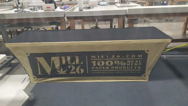 Mill26 gold banner advertises 100% real hemp paper in backlit stretch table cover