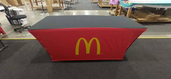 Red and black backlit stretch table cover with McDonalds golden arches logo