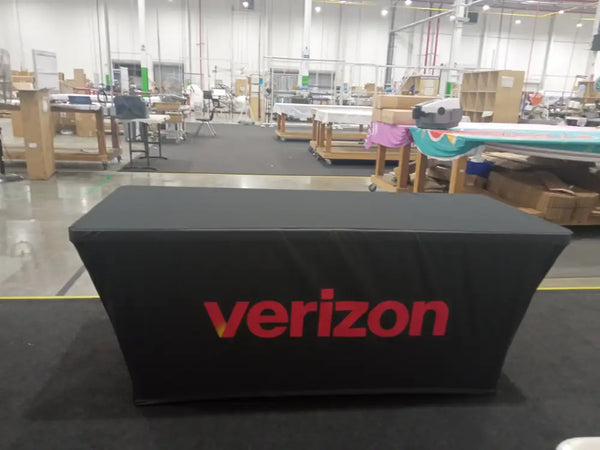 Black stretch table cover with bold red Verizon logo