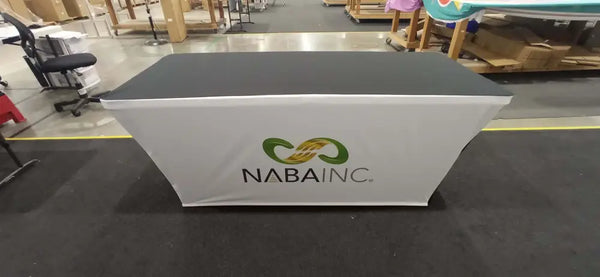White stretch table cover with black top and NABA Inc. green logo