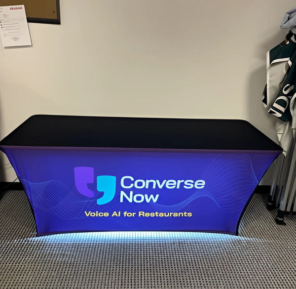 Backlit stretch table cover with Converse Now black and blue banner
