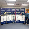 Man in blue shirt next to five Classic 24 Inch Retractable Banner Stands
