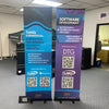 Two Classic 24 Inch retractable banner stands with blue-purple banners in office