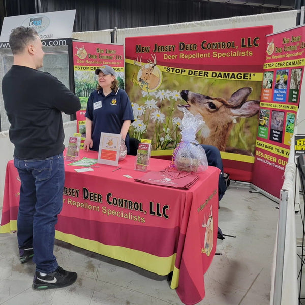 Red and yellow drape table cover with New Jersey Deer Control LLC