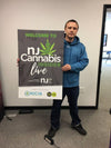 NJ Cannabis Insider Live mounted poster with green text and leaf logo