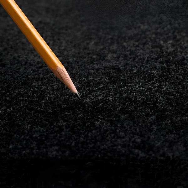 Yellow pencil on black felt of Soft Carpet Interlocking Trade Show Flooring