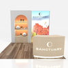Beige curved reception desk with Sanctuary logo and circular emblem in 10x10 VHE-Modular Inline Exhibit Kit 09a