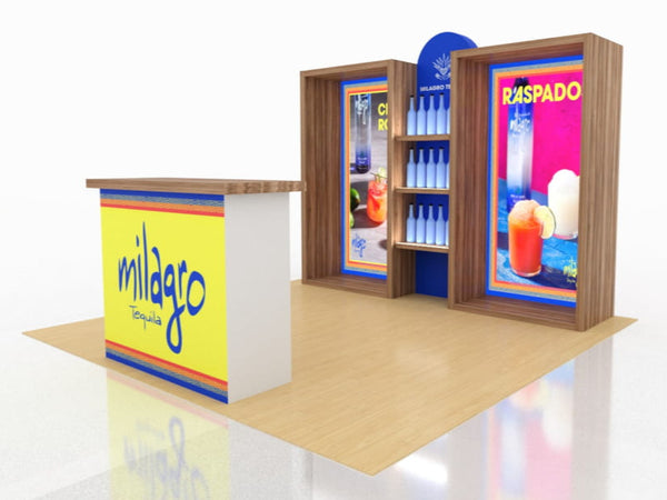 Milagro Tequila booth with yellow blue accents, cocktail posters, stocked shelves